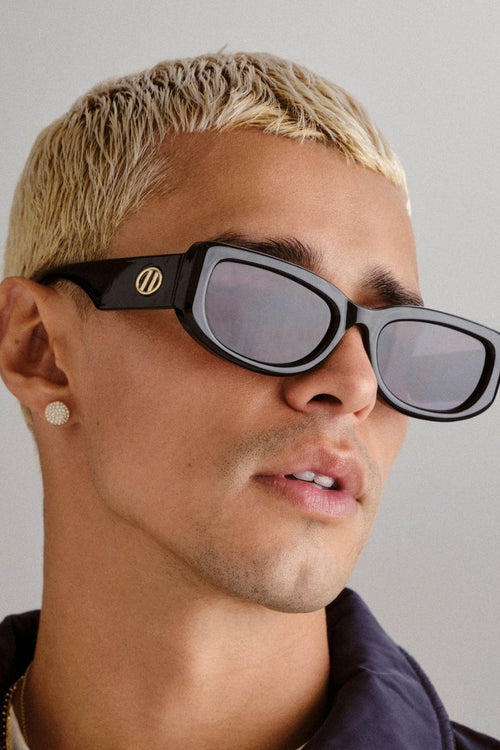 Black rectangular sunglasses with narrow frames and khaki-tinted mono lenses.