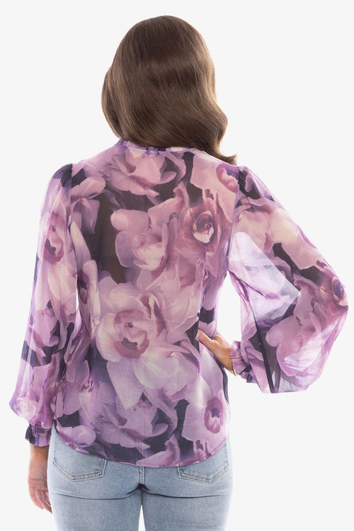 model in purple floral top