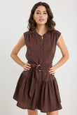 Woman wearing a brown dress with a belt on a white background