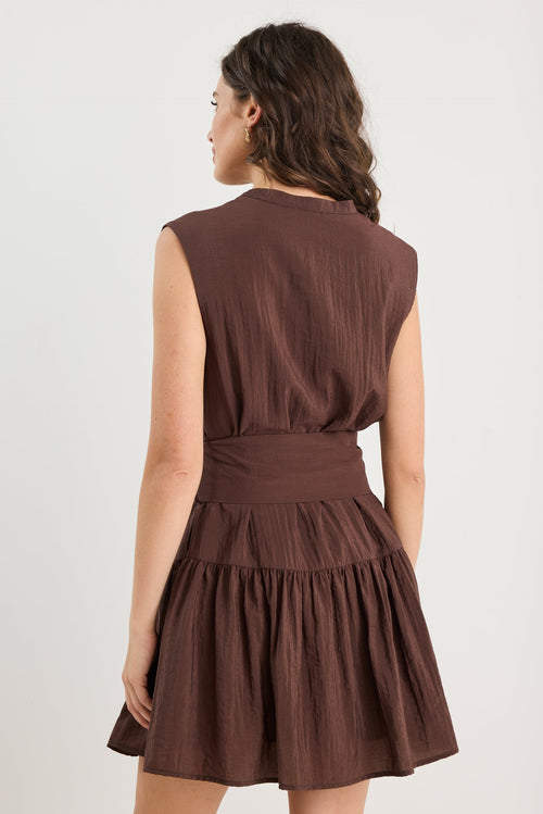 Woman wearing a brown dress on a white background