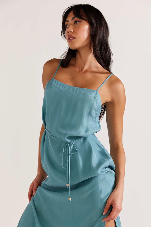 model wears a blue slip dress