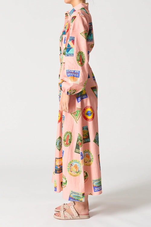 Person wearing a pink outfit with colorful graphic designs on a white background