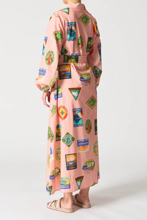 Long-sleeve dress with colorful vintage label pattern on a white background
