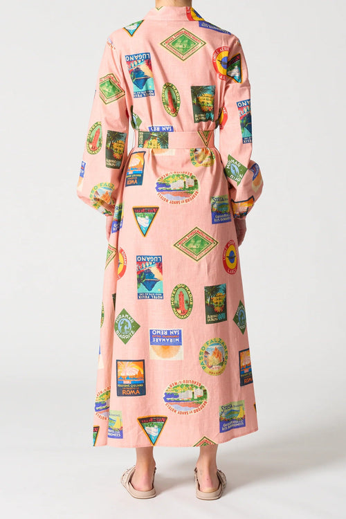 Long pink dress with colorful graphic patterns on a white background