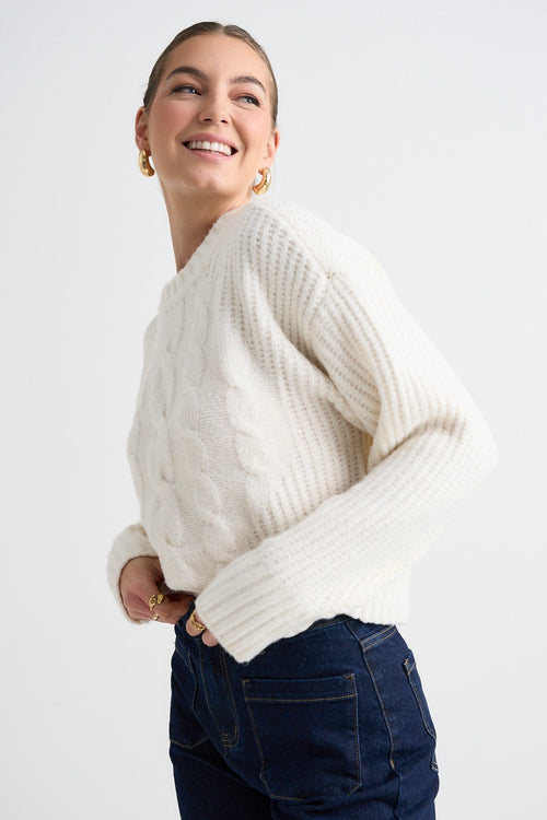 model wears a white knit jumper