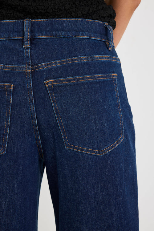 Close-up of blue jeans with a plain background