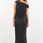 Woman wearing a black one-shoulder dress on a white background