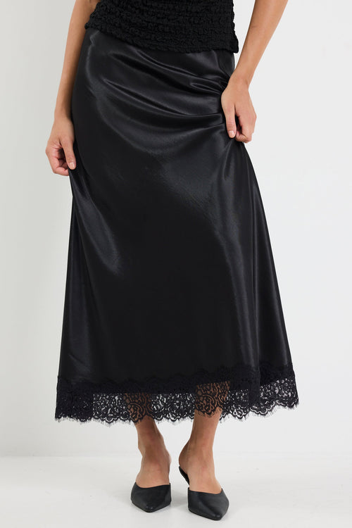Black satin skirt with lace hem on a white background
