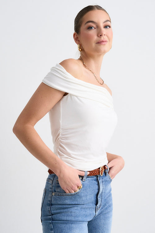 model wears a white off the shoulder top