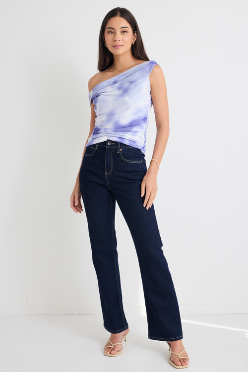 model wears purple sleeveless top and jeans