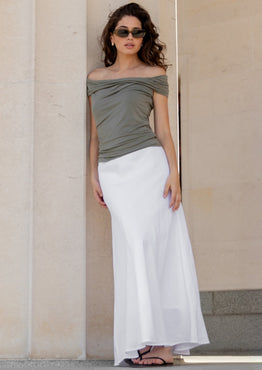 Woman standing against a classical building with columns