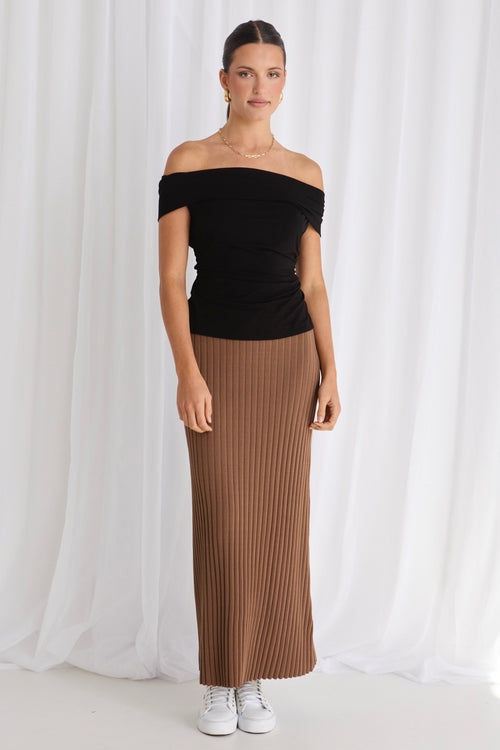 model wears a brown rib knit skirt