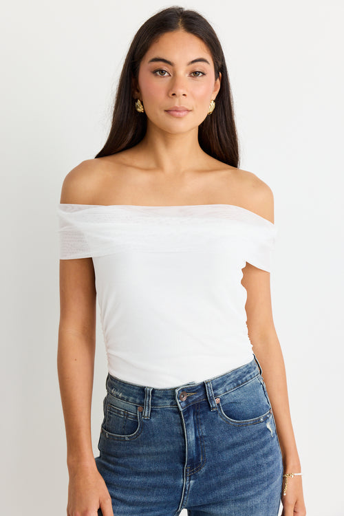 model wears a mesh white off the shoulder top