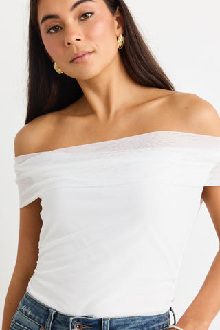 model wears a mesh white off the shoulder top