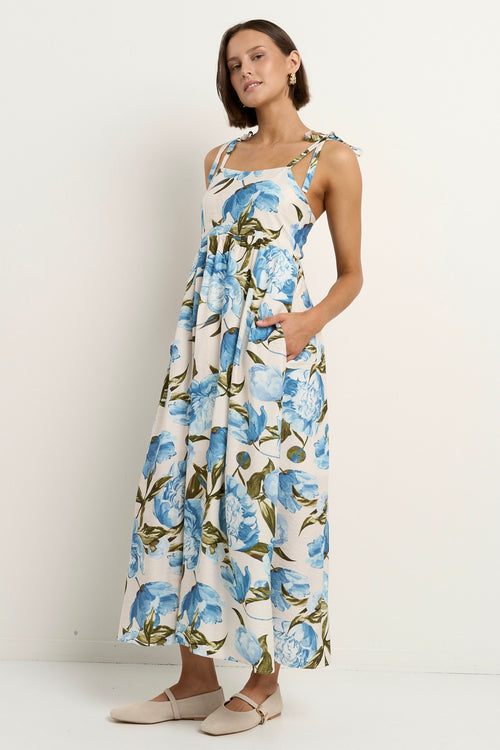 model wears a blue and white floral maxi dress 
