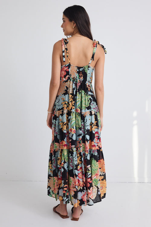 model wears a black floral maxi dress