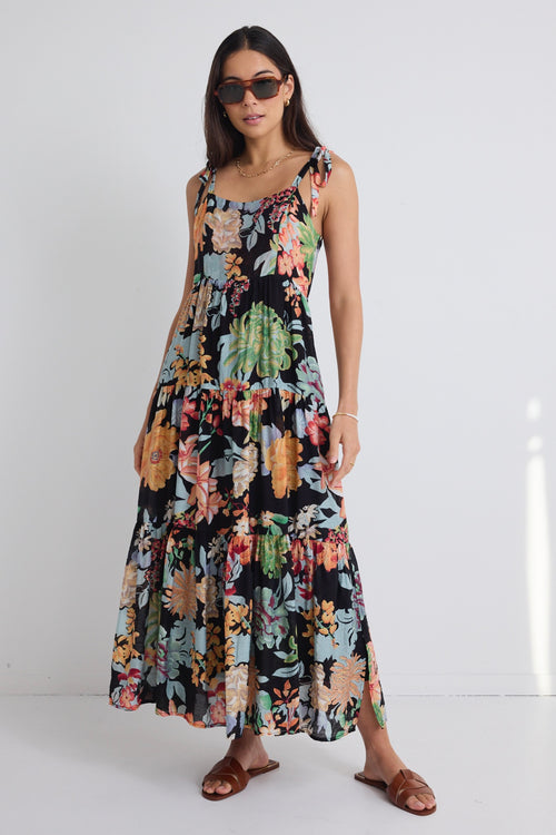 model wears a black floral maxi dress