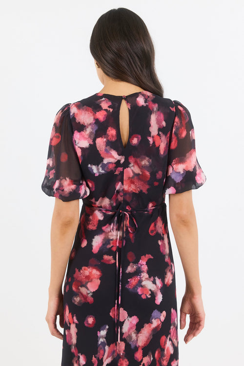 Woman wearing a floral dress with a white background