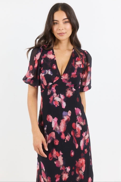 Woman wearing a floral dress on a white background
