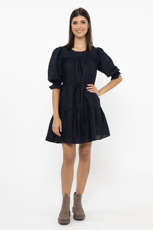 model wears a navy linen mini dress