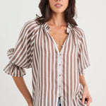 Woman wearing a striped shirt and jeans on a white background