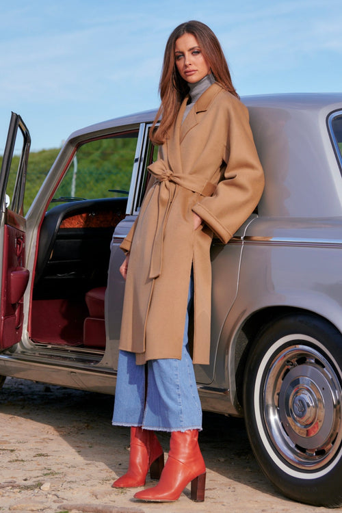 model wears a brown coat 