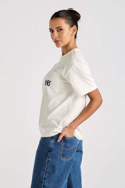 model wears white oversized tee and blue denim jeans