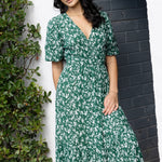 model posing outside in green floral maxi dress