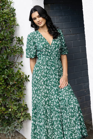 model posing outside in green floral maxi dress