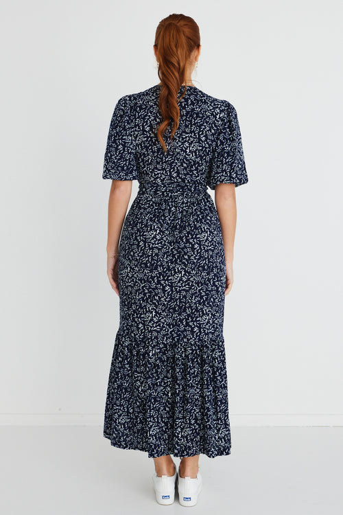 model wears a navy floral maxi dress