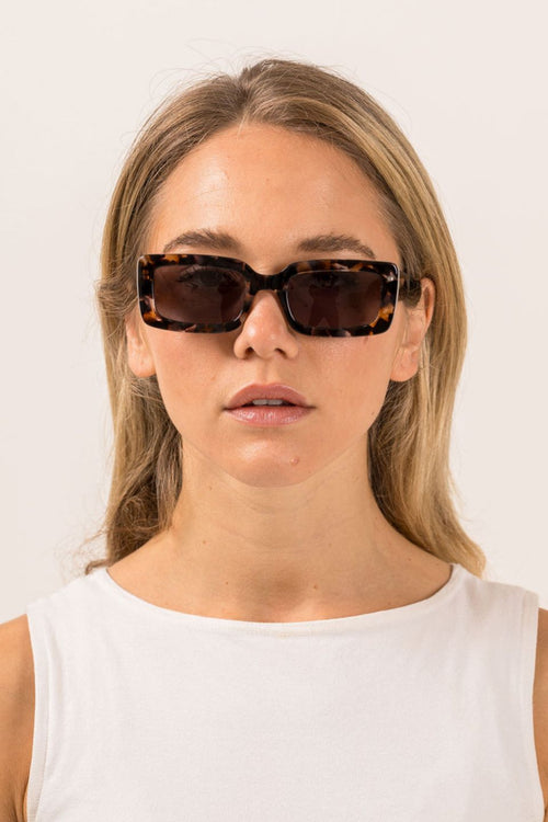 model wears brown sunglasses