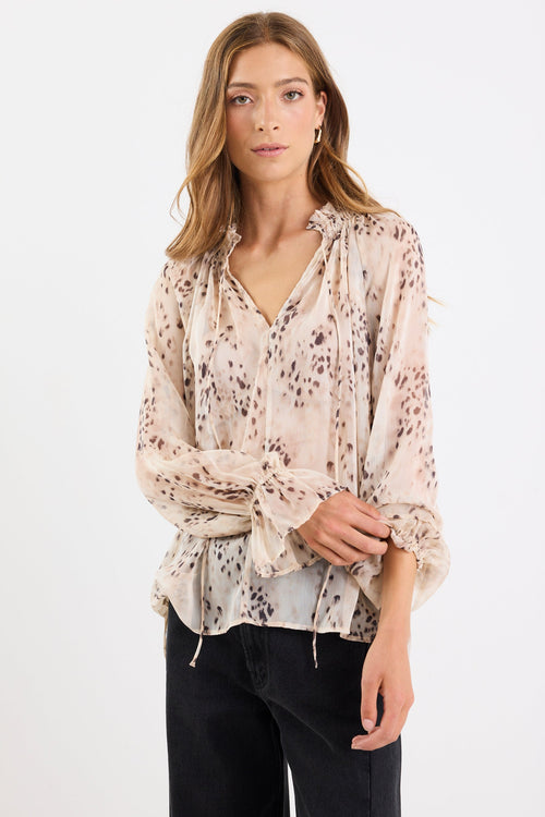 Woman wearing a floral blouse with a white background