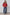 Woman wearing a red blouse and blue jeans against a white background