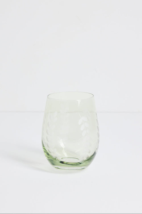 A clear stemless wine glass with a textured, dimpled pattern on a white studio background.