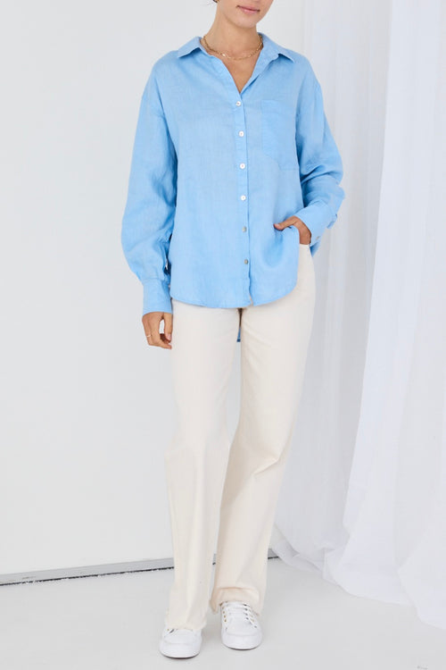 model wears a blue linen shirt