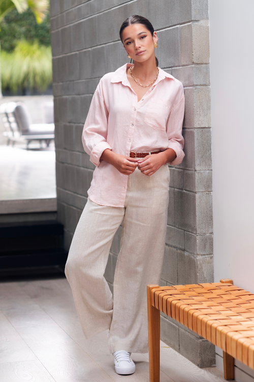 Model wears pink linen shirt with linen pants
