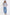 Woman wearing a striped sweater and blue jeans on a white background