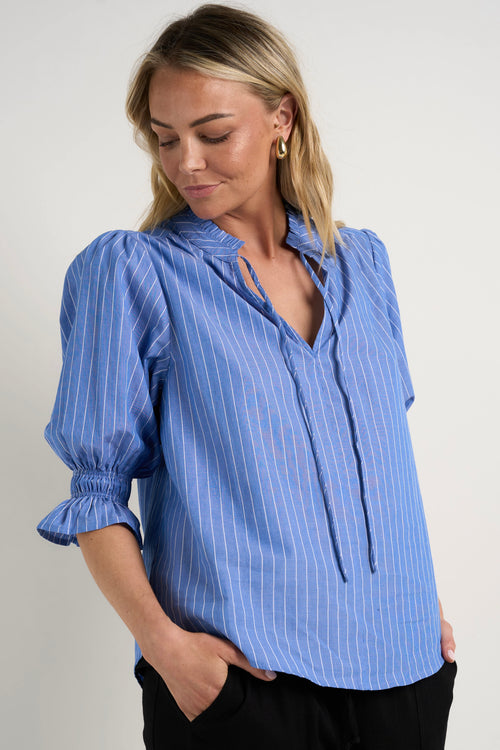 Model wears a blue stripe blouse