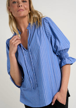 Model wears a blue stripe blouse