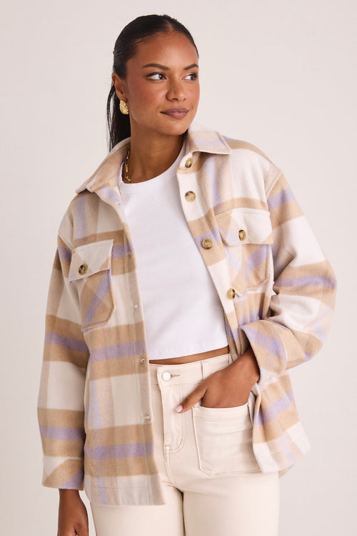 model wears a tan shacket