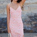 model wears pink midi dress