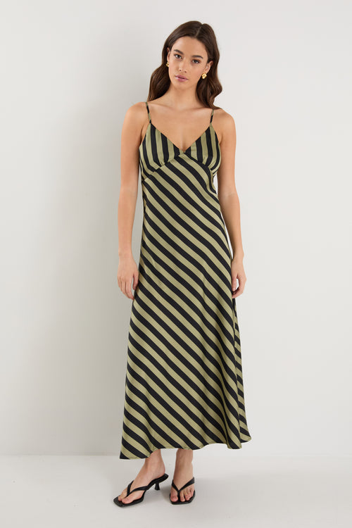 model wears a black and khaki stripe maxi dress with black heels 