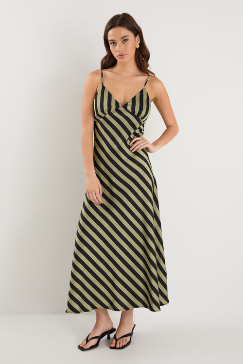 model wears a black and khaki stripe maxi dress with black heels 