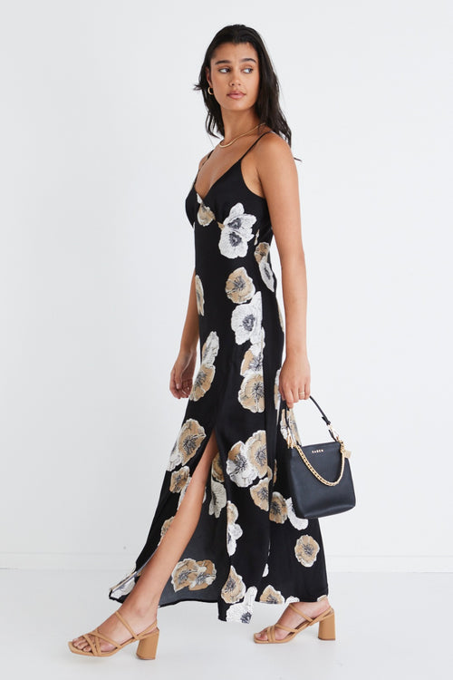 model wears a black floral dress
