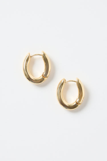A pair of small oval-shaped wavy gold hoop earrings photographed on a clean white background.