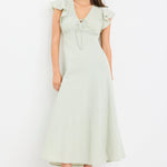 Woman wearing a sage green gingham midi dress with flutter sleeves and keyhole tie neckline.