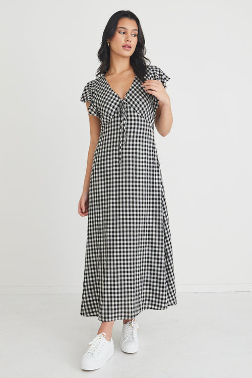 model wears a black and white gingham maxi dress