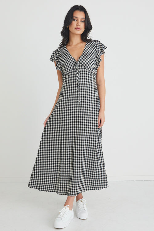 model wears a black and white gingham maxi dress