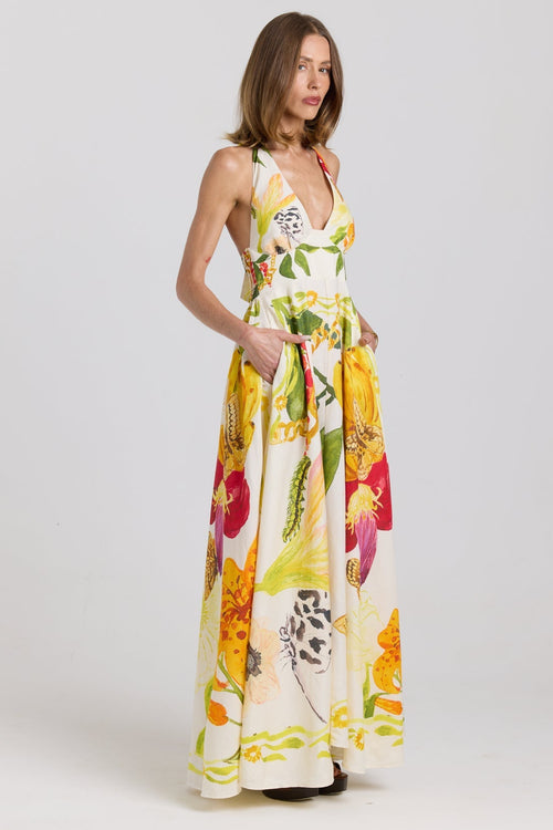 Woman wearing a colorful floral dress on a white background