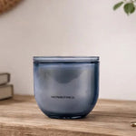 Blue glass container on a wooden surface with a blurred background